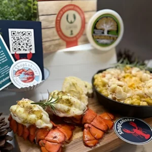 Cooked lobster tails with mac and cheese next to ShopLobster gift box and packaging – perfect lobster gift box meal